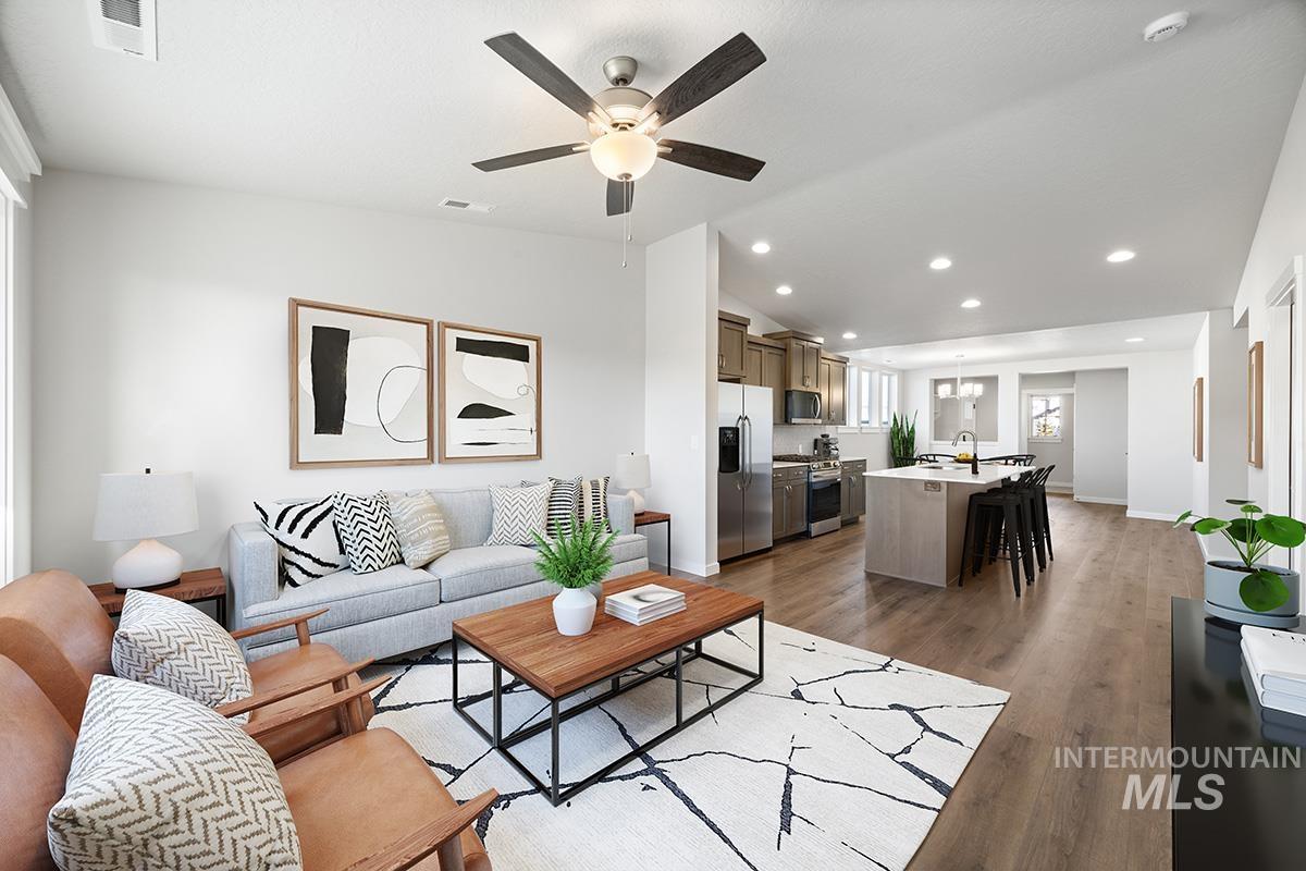 283 West Norwich Street Meridian, ID 83642 - Photo 10 of 25 Living area with recessed lighting, lofted ceiling, light wood finished floors, and a ceiling fan