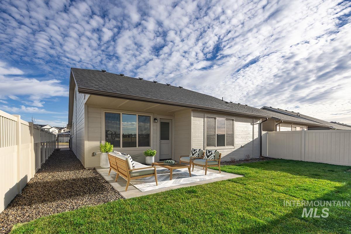 283 West Norwich Street Meridian, ID 83642 - Photo 16 of 25 Back of house featuring a fenced backyard, a patio, an outdoor hangout area, and roof with shingles