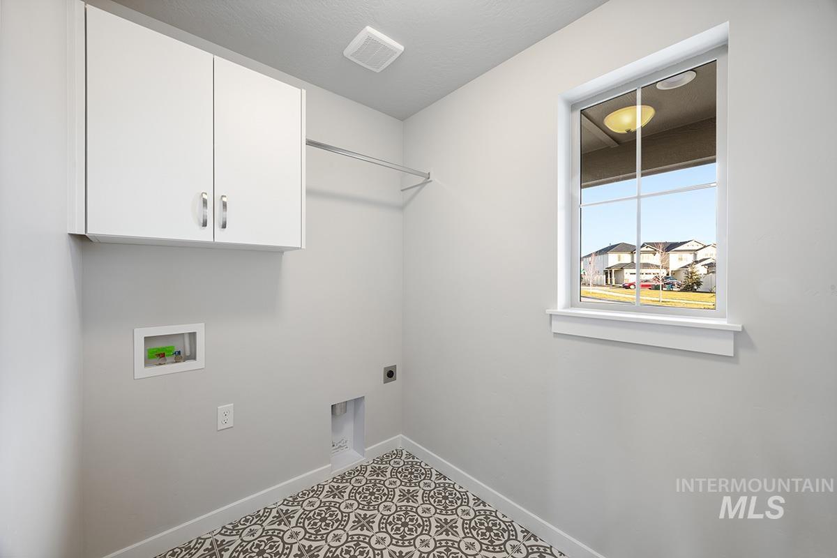 283 West Norwich Street Meridian, ID 83642 - Photo 3 of 25 Laundry room featuring washer hookup, electric dryer hookup, and cabinet space