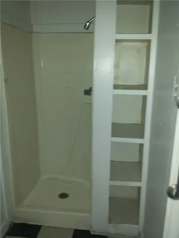a bathroom with a glass shower door
