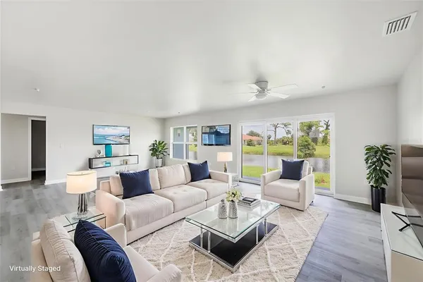 a living room with furniture or couch and a potted plant