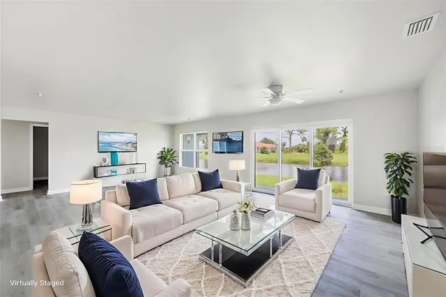 a living room with furniture or couch and a potted plant