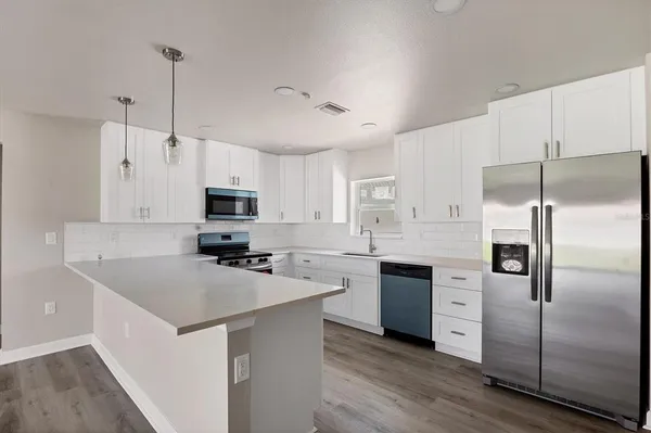 a kitchen with granite countertop white cabinets and white appliances