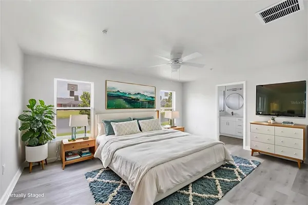 a bedroom with a bed and a flat screen tv