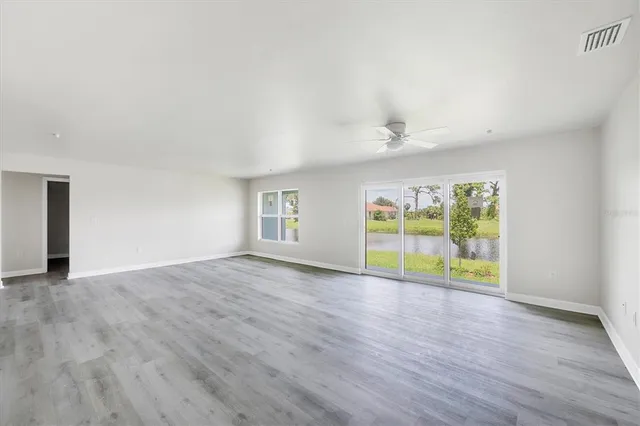 a view of a kitchen with wooden floor and a refrigerator