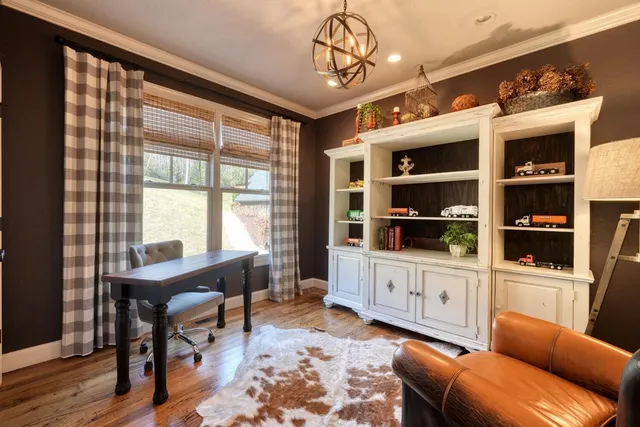 a view of a livingroom with a flat screen tv a ceiling fan and window