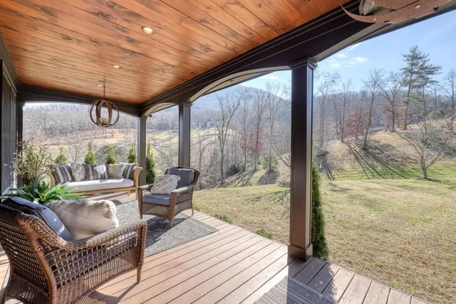 a view of a hallway with wooden floor and a dining room