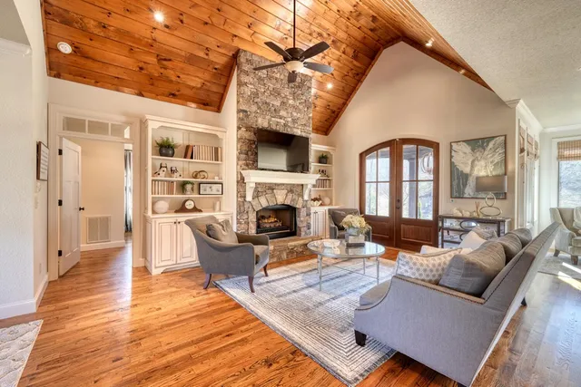 a living room with furniture fireplace and a fireplace