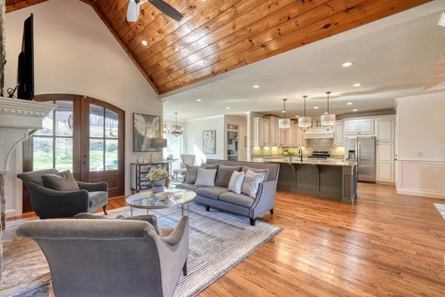 a living room with furniture and kitchen view