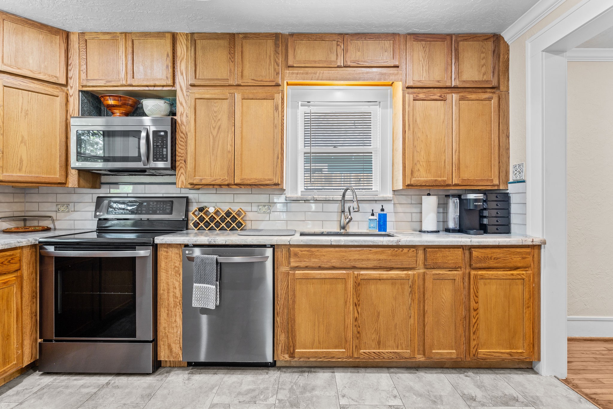 1526 Lawson Street Houston, TX 77023 - Photo 15 of 25 a kitchen with stainless steel appliances granite countertop a stove a sink and a refrigerator