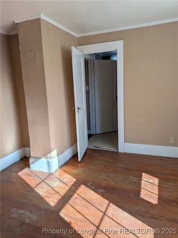 a view of a room with wooden floor and potted plant