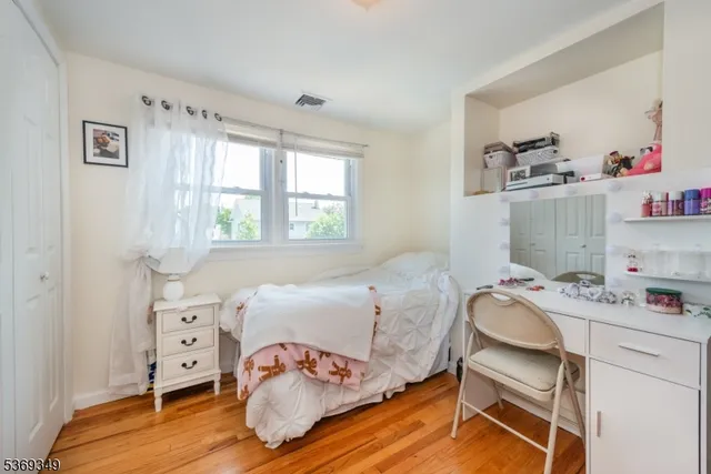 a bedroom with a bed and a chair in it