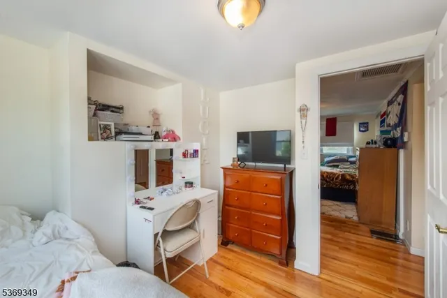 a room with furniture a flat tv screen and a dresser