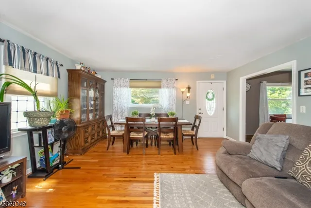 a living room with furniture dining table and a window