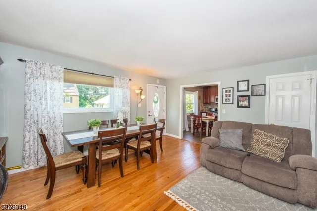 a living room with furniture wooden floor and a window
