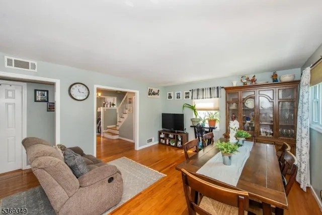 a living room with furniture a window and a flat screen tv