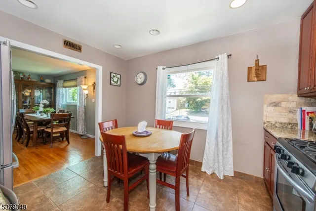 a view of a dining room with furniture and a window