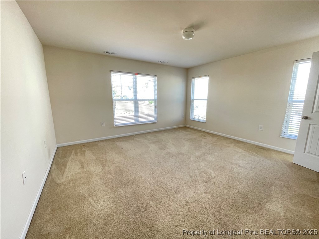 1023 Saffron Loop Durham, NC 27713 - Photo 12 of 18 an empty room with windows