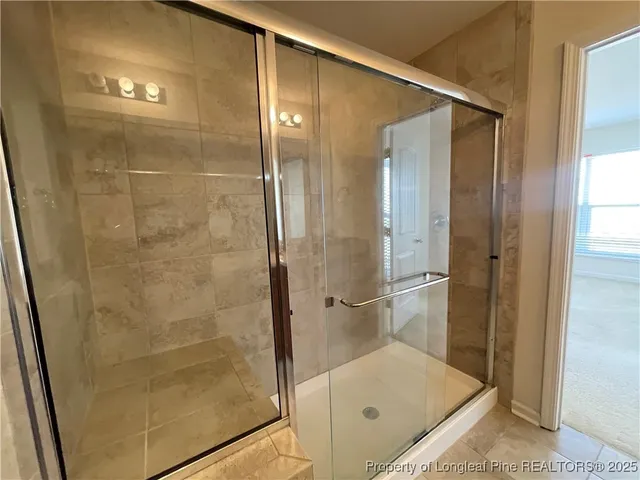 a bathroom with a shower and a sink
