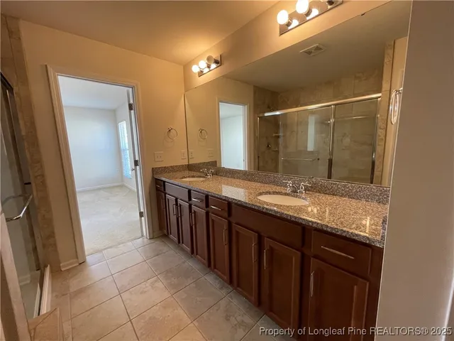 a bathroom with a granite countertop sink a mirror and a vanity