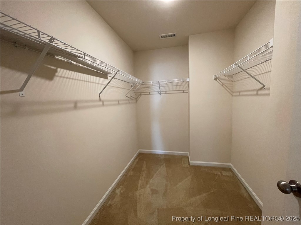 1023 Saffron Loop Durham, NC 27713 - Photo 15 of 18 a view of a room with racks on the wall