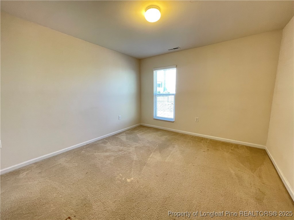 1023 Saffron Loop Durham, NC 27713 - Photo 16 of 18 an empty room with windows