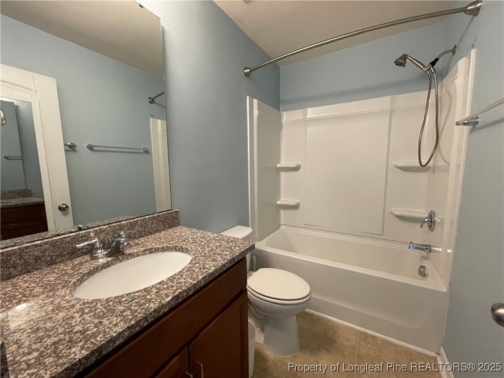 1023 Saffron Loop Durham, NC 27713 - Photo 17 of 18 a bathroom with a granite countertop sink toilet and shower
