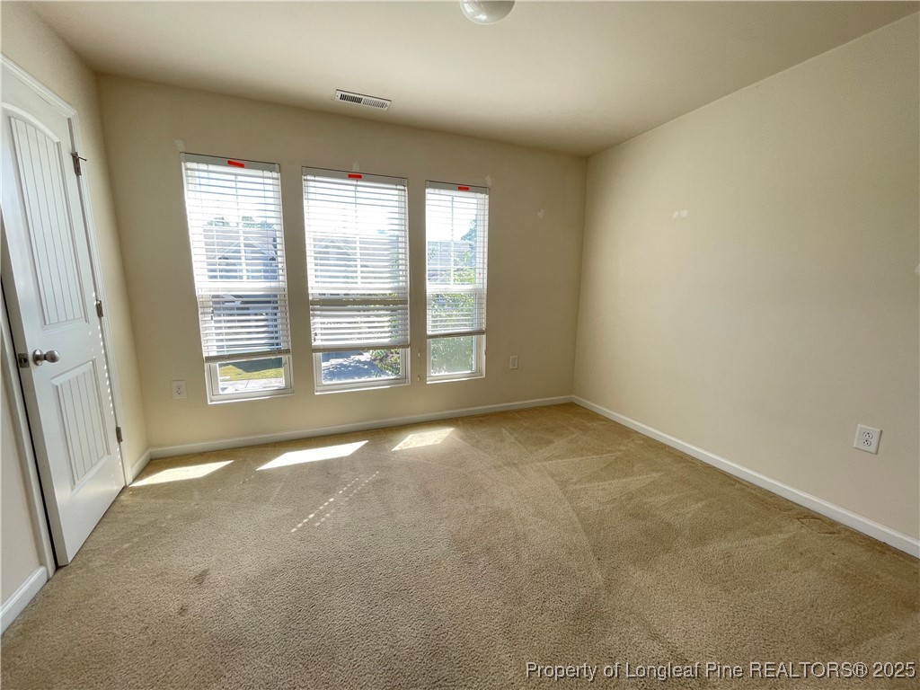 1023 Saffron Loop Durham, NC 27713 - Photo 10 of 18 a view of an empty room with a window