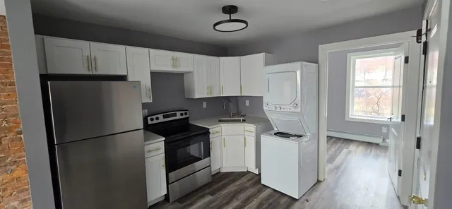 a kitchen with stainless steel appliances granite countertop a refrigerator sink and stove