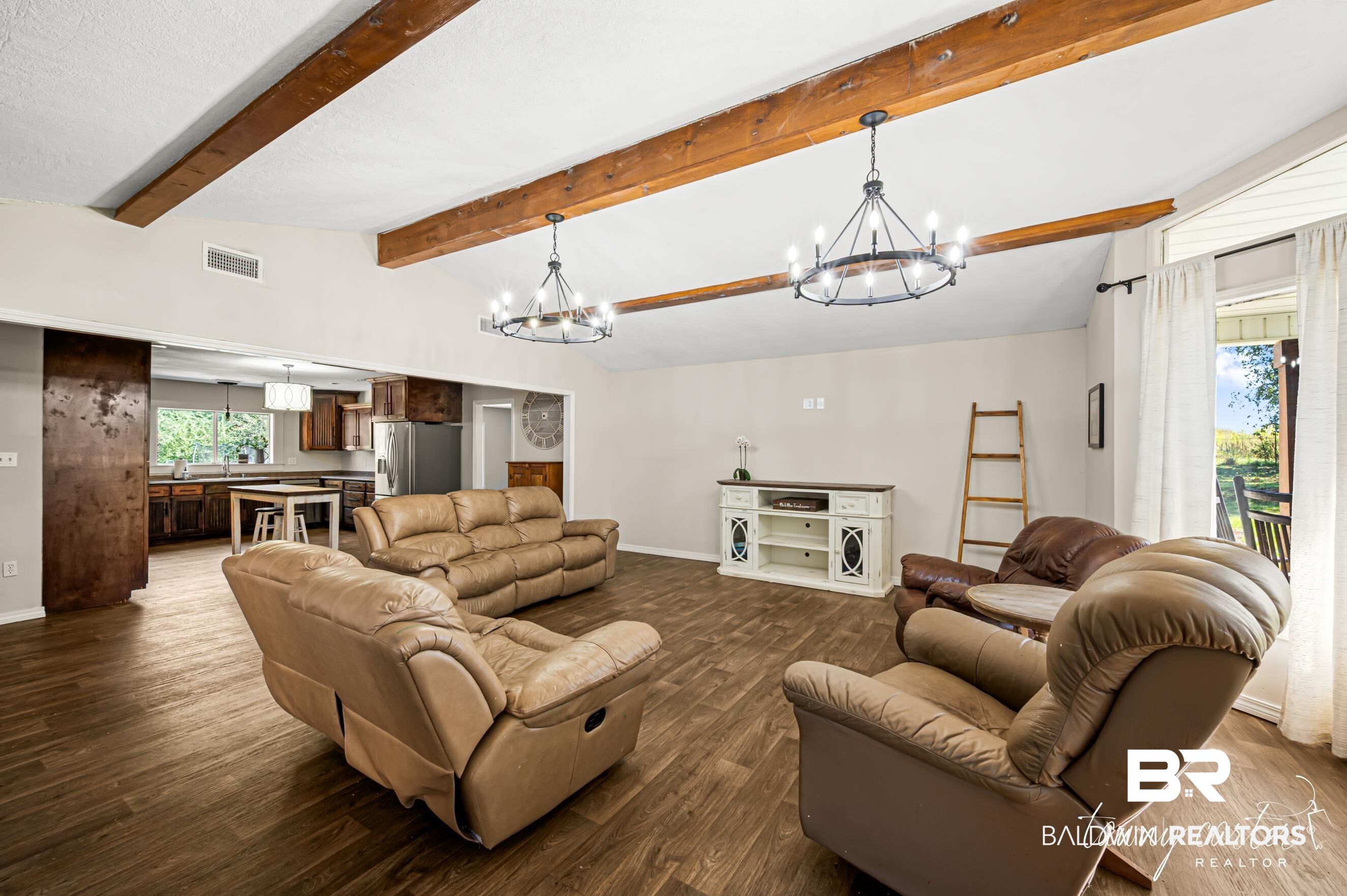 3086 Wild Fork Road Frisco City, AL 36445 - Photo 19 of 30 Living room with wood finished floors and a chandelier