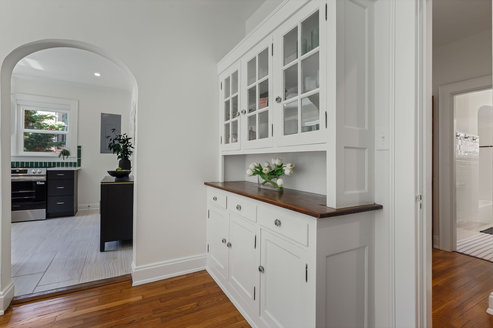 2005 Convent Place, Unit 1 Nashville, TN 37212 - Photo 24 of 41 a kitchen with granite countertop white cabinets and wooden floor