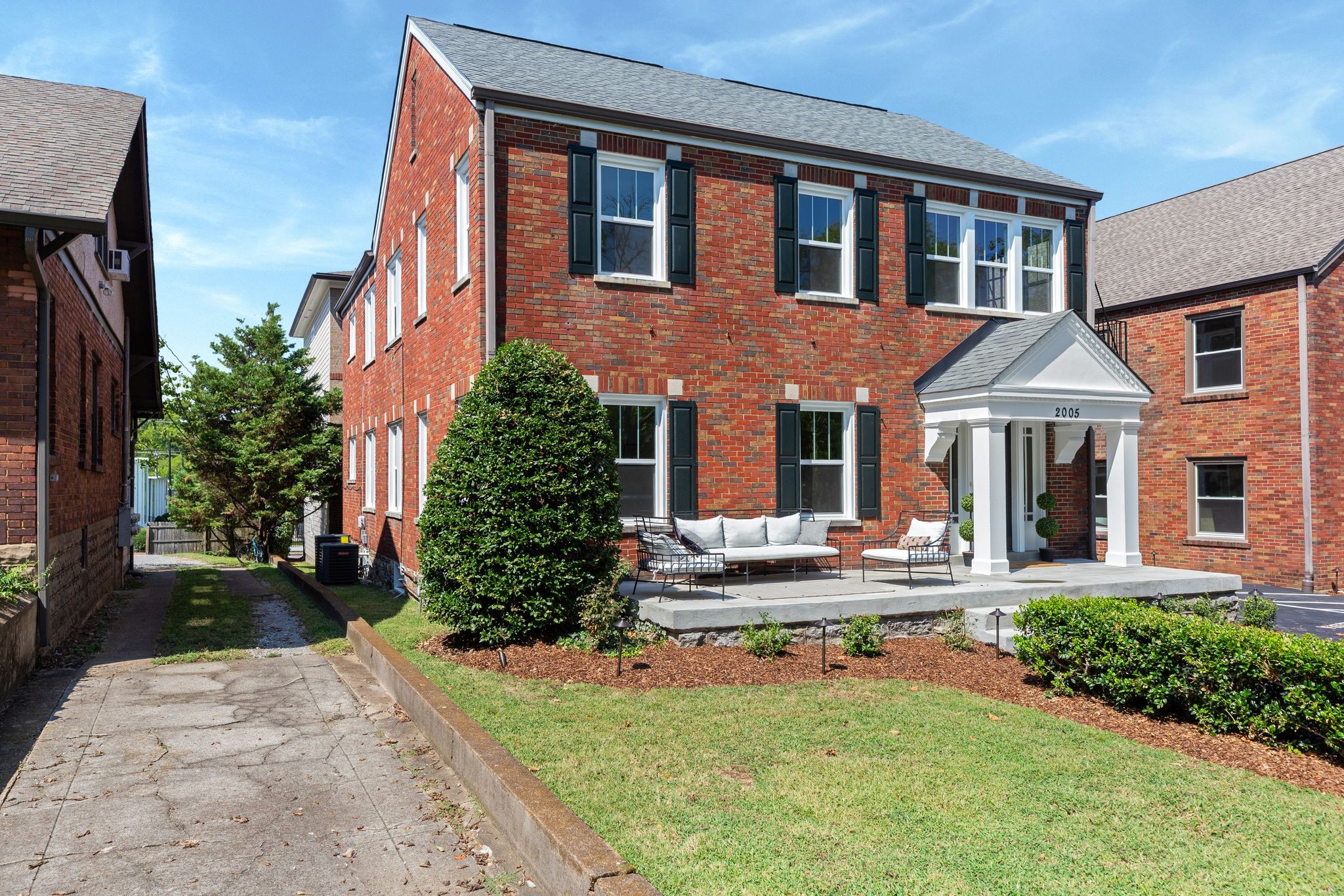 2005 Convent Place, Unit 1 Nashville, TN 37212 - Photo 4 of 41 a front view of a house with garden and porch