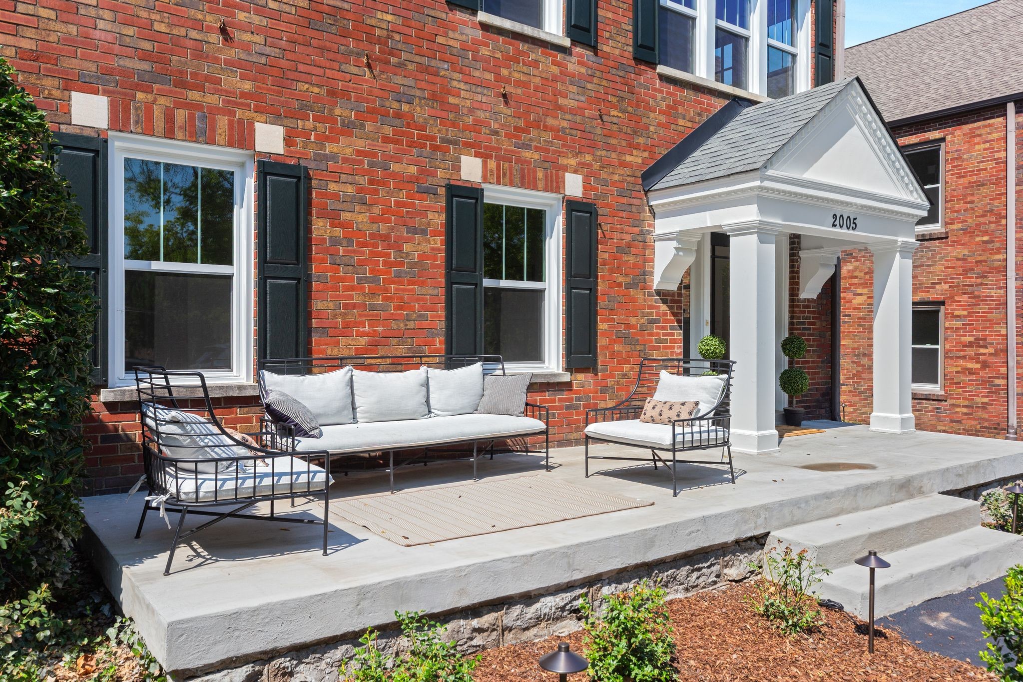 2005 Convent Place, Unit 1 Nashville, TN 37212 - Photo 5 of 41 a view of a patio with couches table and chairs and potted plants