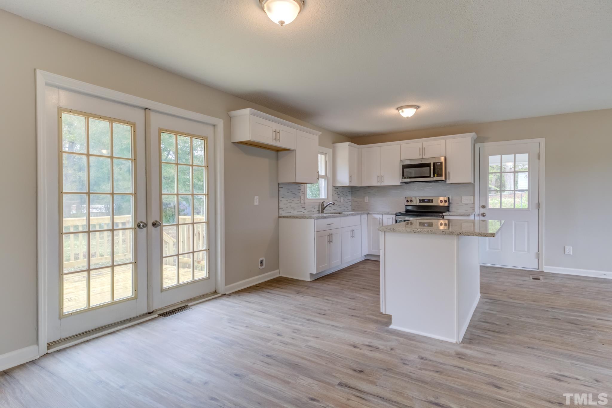 3600 Edgemont Road Wendell, NC 27591 - Photo 12 of 30 a kitchen with cabinets and wooden floor