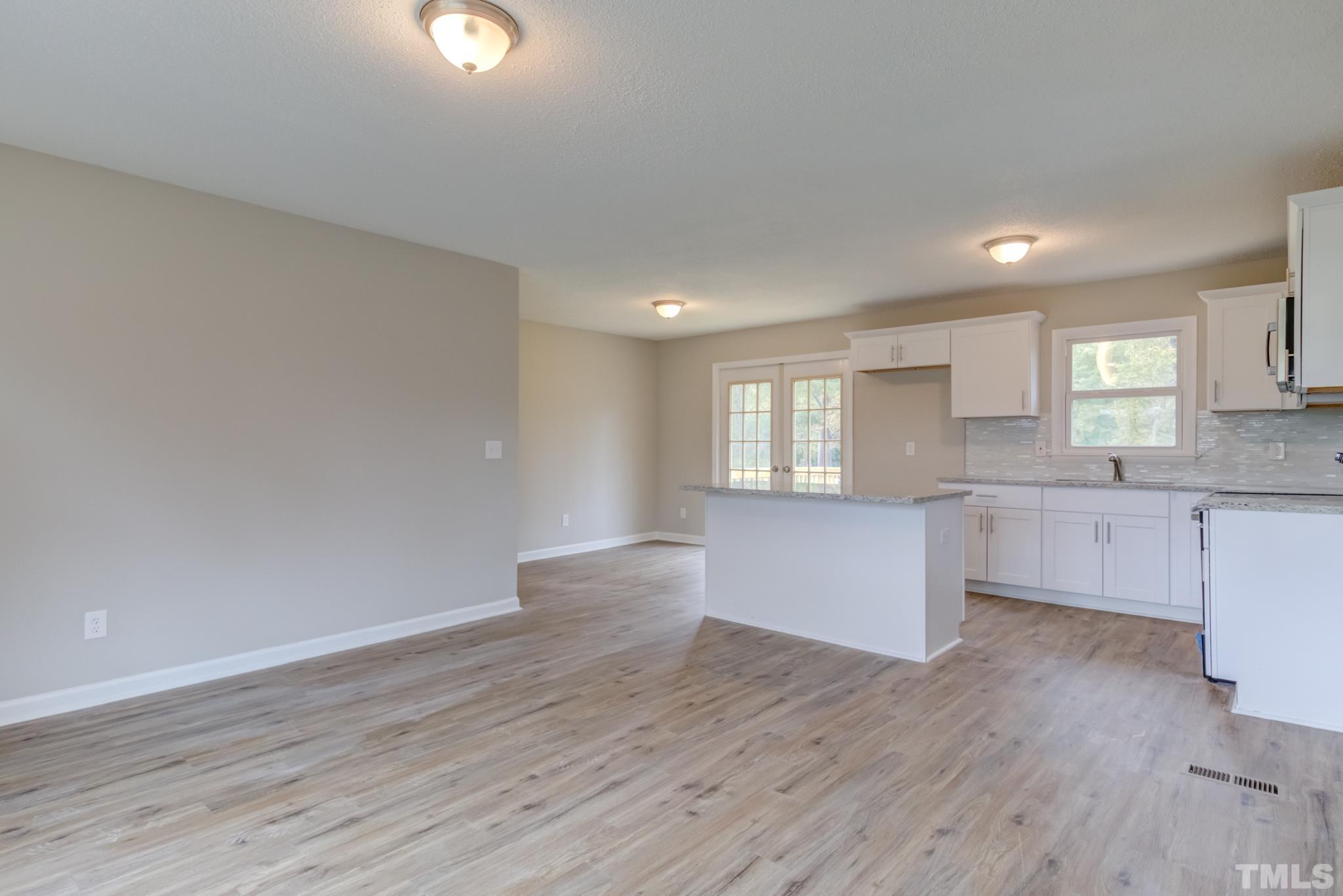3600 Edgemont Road Wendell, NC 27591 - Photo 14 of 30 a view of an empty room and window and wooden floor