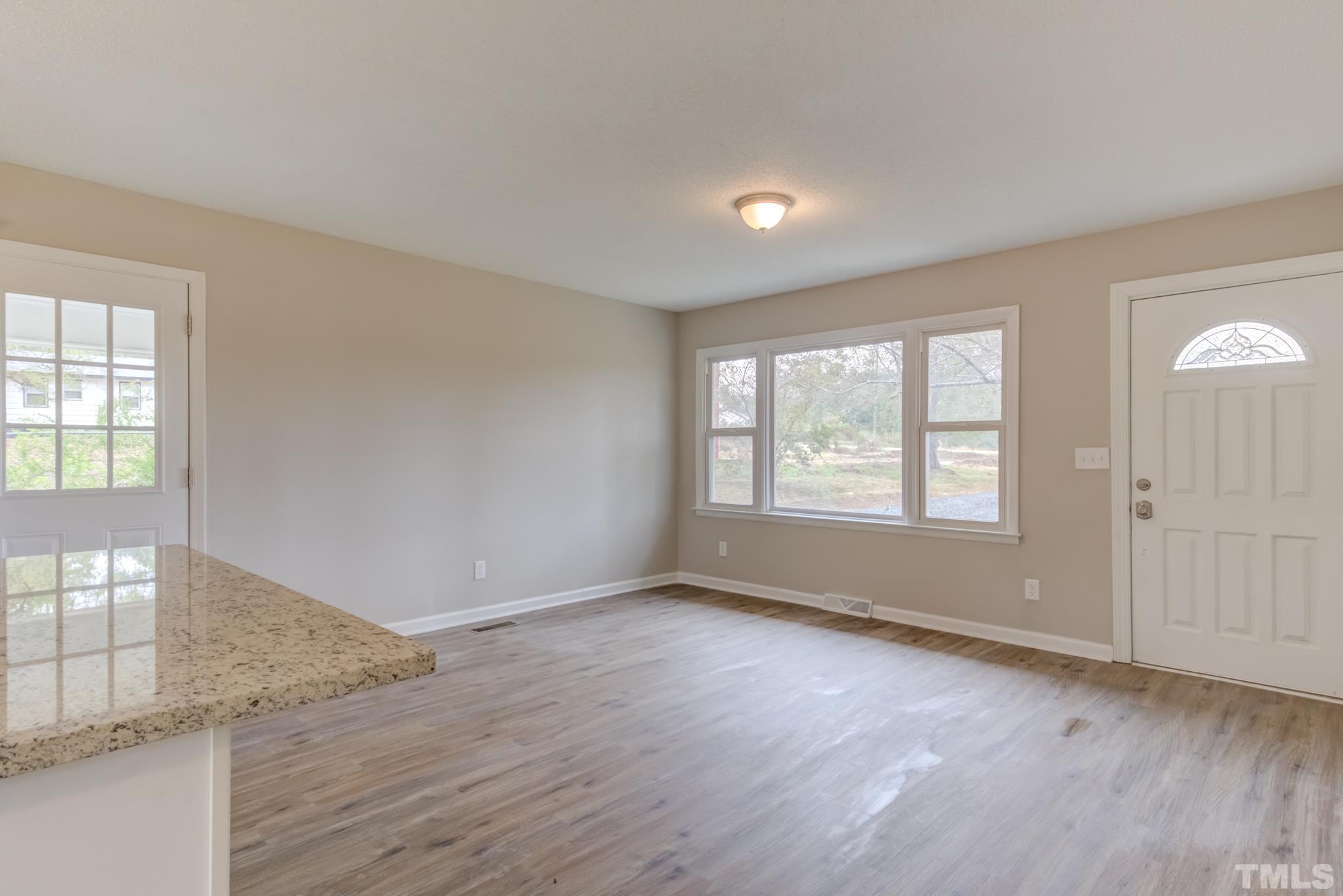 3600 Edgemont Road Wendell, NC 27591 - Photo 15 of 30 an empty room with wooden floor and windows