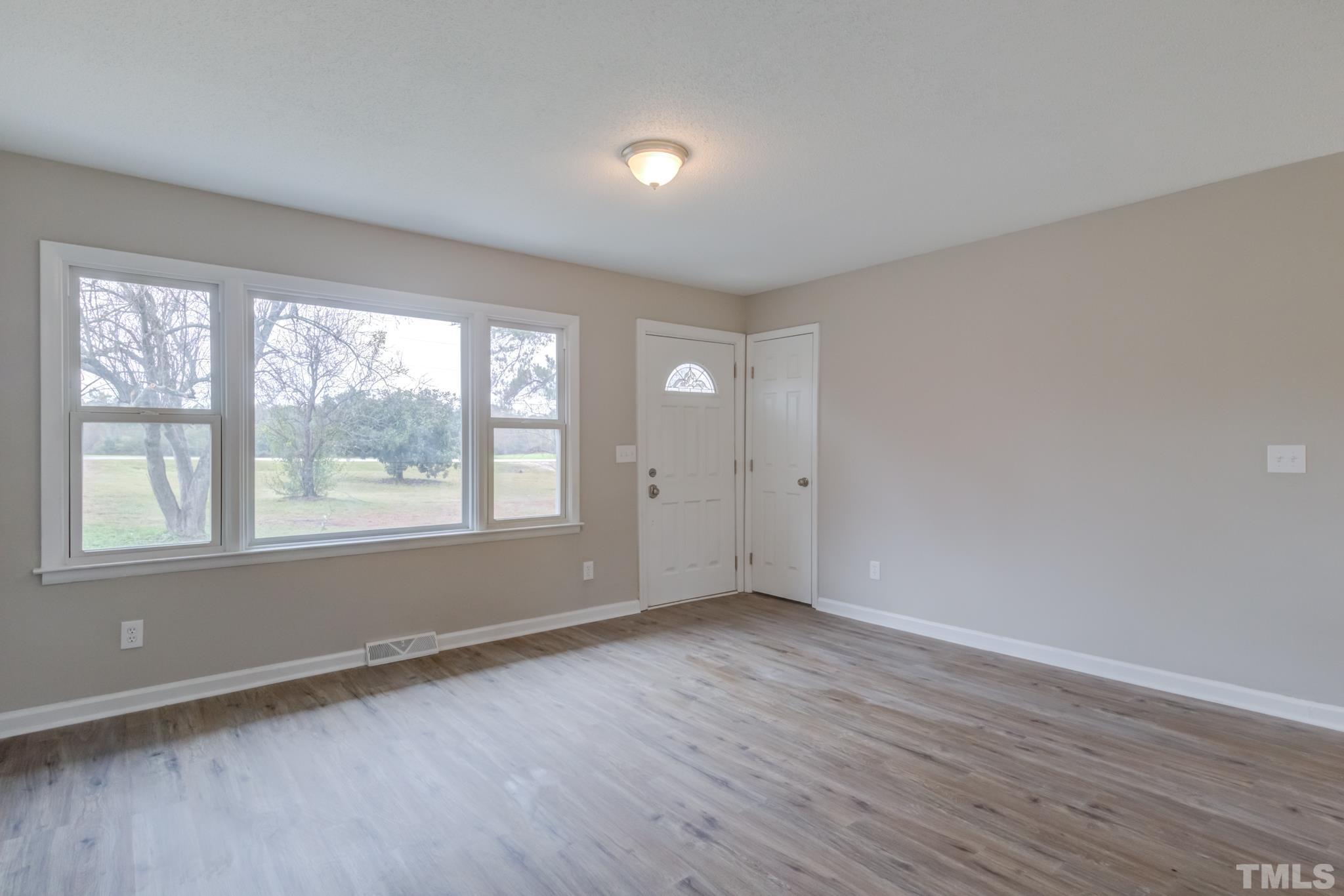 3600 Edgemont Road Wendell, NC 27591 - Photo 16 of 30 an empty room with wooden floor and windows