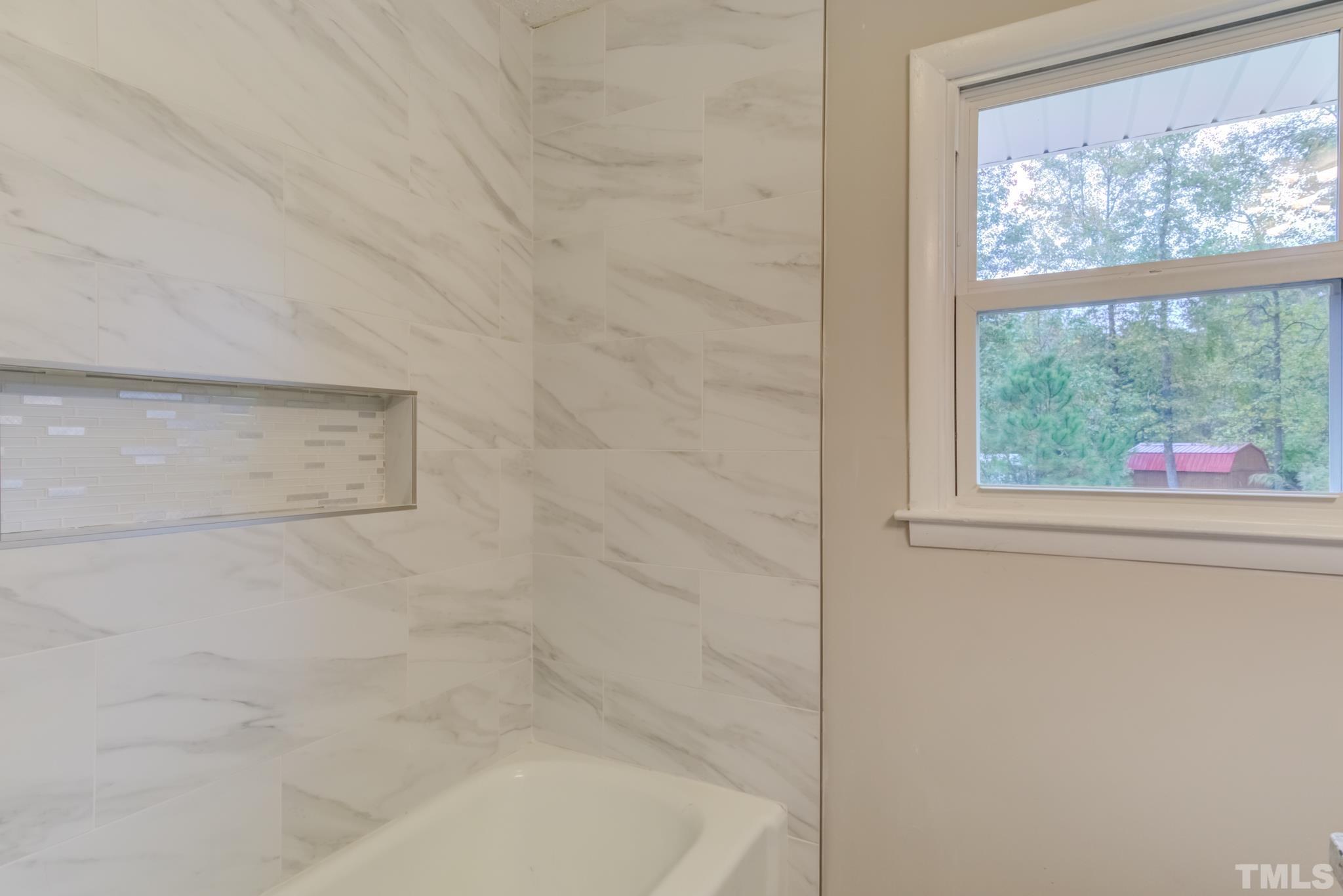 3600 Edgemont Road Wendell, NC 27591 - Photo 19 of 30 a view of a bathroom with a window and a shower