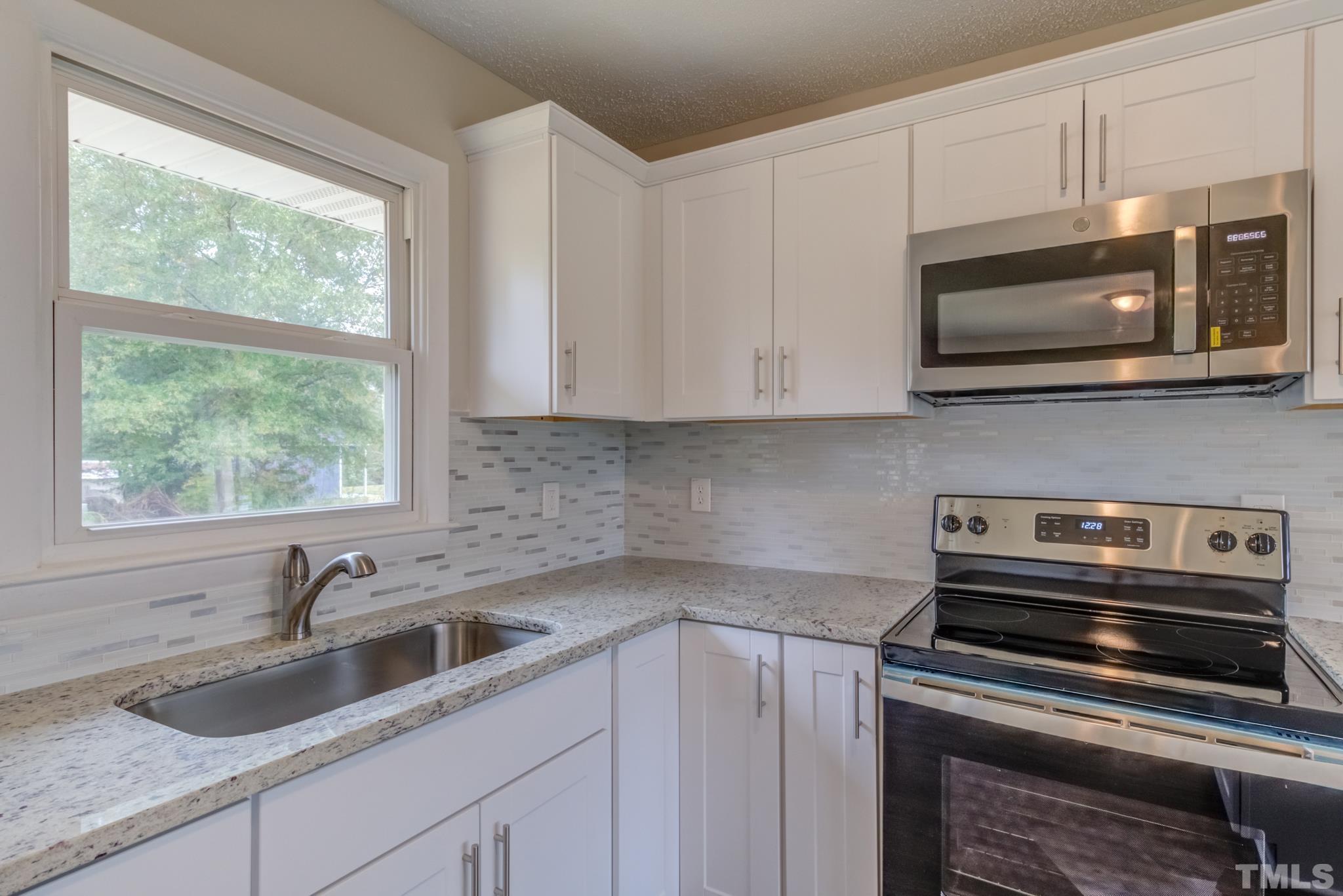 3600 Edgemont Road Wendell, NC 27591 - Photo 5 of 30 a kitchen with appliances a sink a stove and cabinets