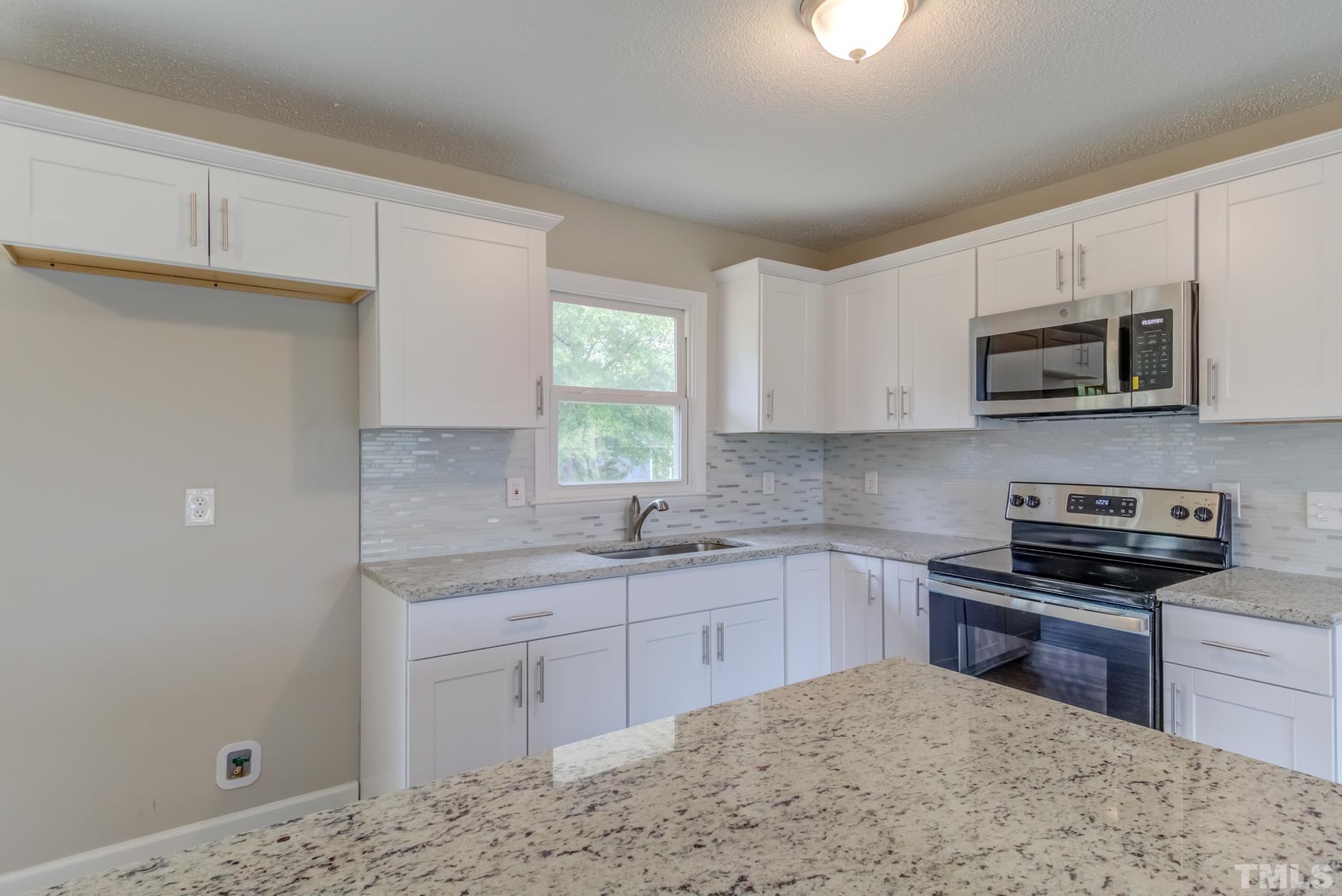 3600 Edgemont Road Wendell, NC 27591 - Photo 7 of 30 a kitchen with stainless steel appliances granite countertop a sink stove and microwave
