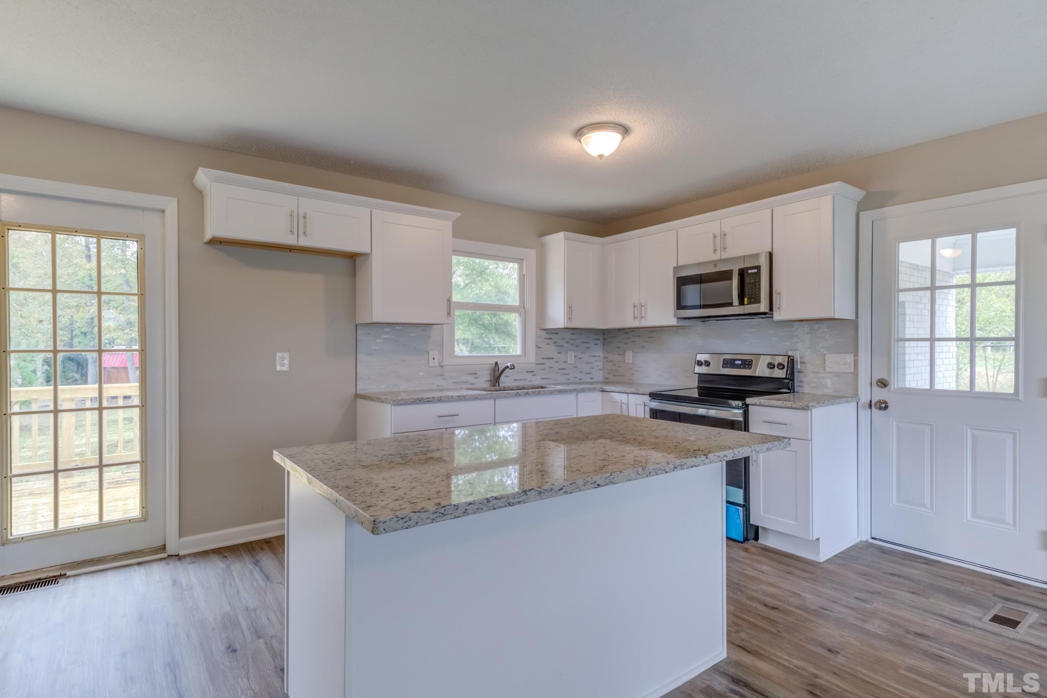 3600 Edgemont Road Wendell, NC 27591 - Photo 8 of 30 a kitchen with sink a microwave and cabinets