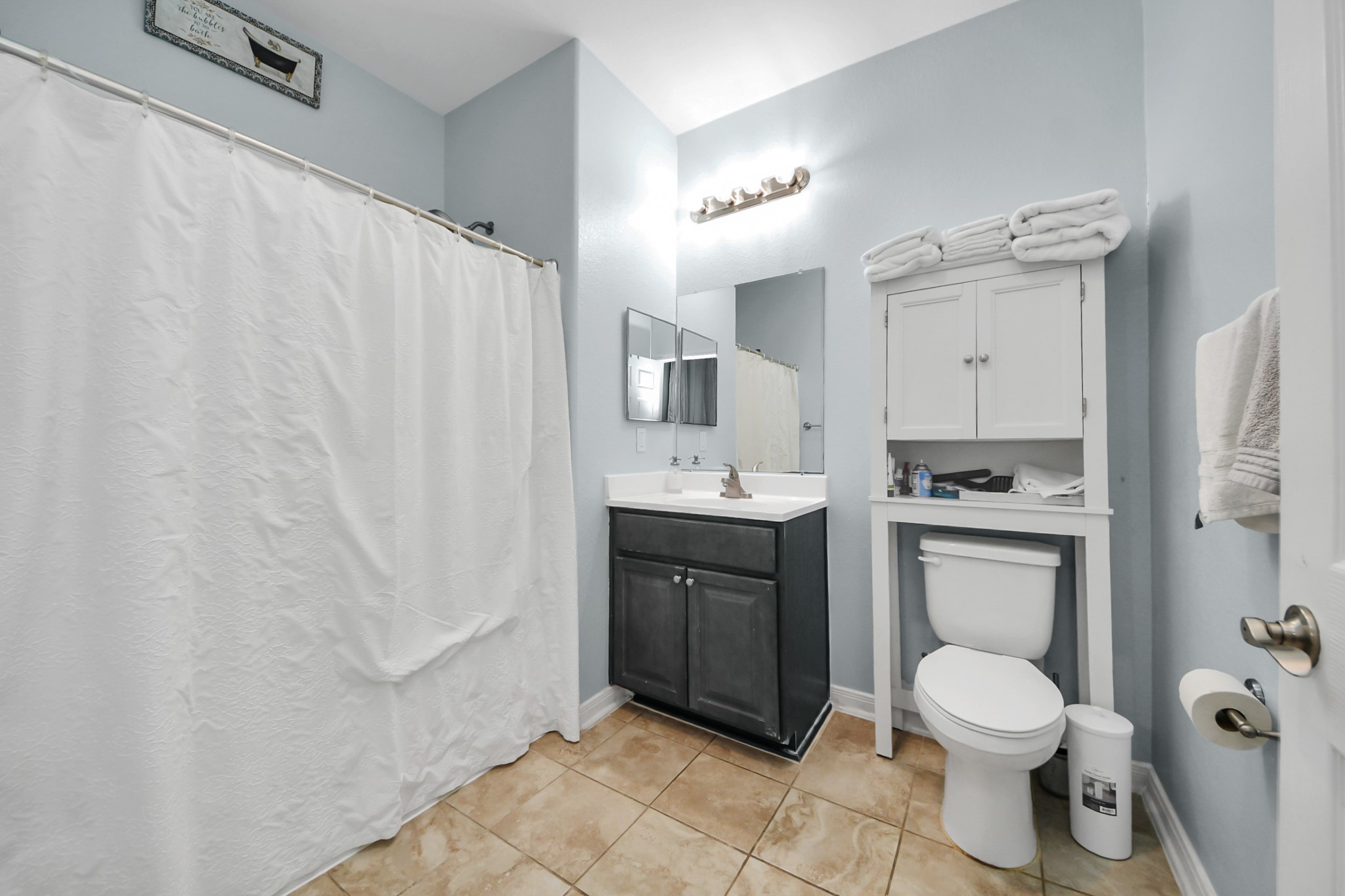 5319 Avenue R Galveston, TX 77551 - Photo 11 of 20 a bathroom with a toilet sink and mirror