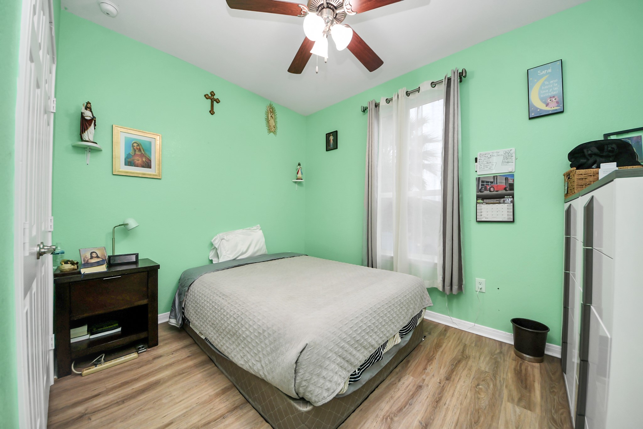 5319 Avenue R Galveston, TX 77551 - Photo 12 of 20 a bedroom with a bed and a chandelier