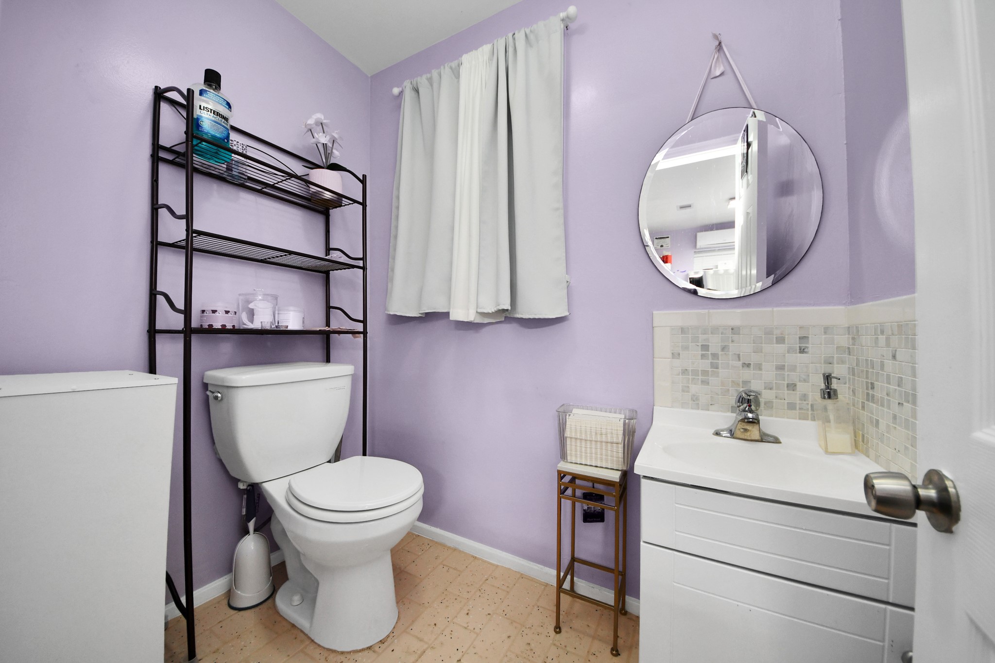 5319 Avenue R Galveston, TX 77551 - Photo 14 of 20 a bathroom with a toilet a sink and a mirror