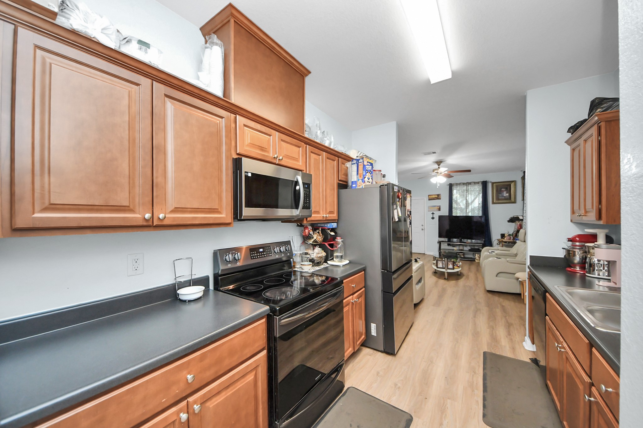 5319 Avenue R Galveston, TX 77551 - Photo 5 of 20 a kitchen with stainless steel appliances a stove microwave and sink