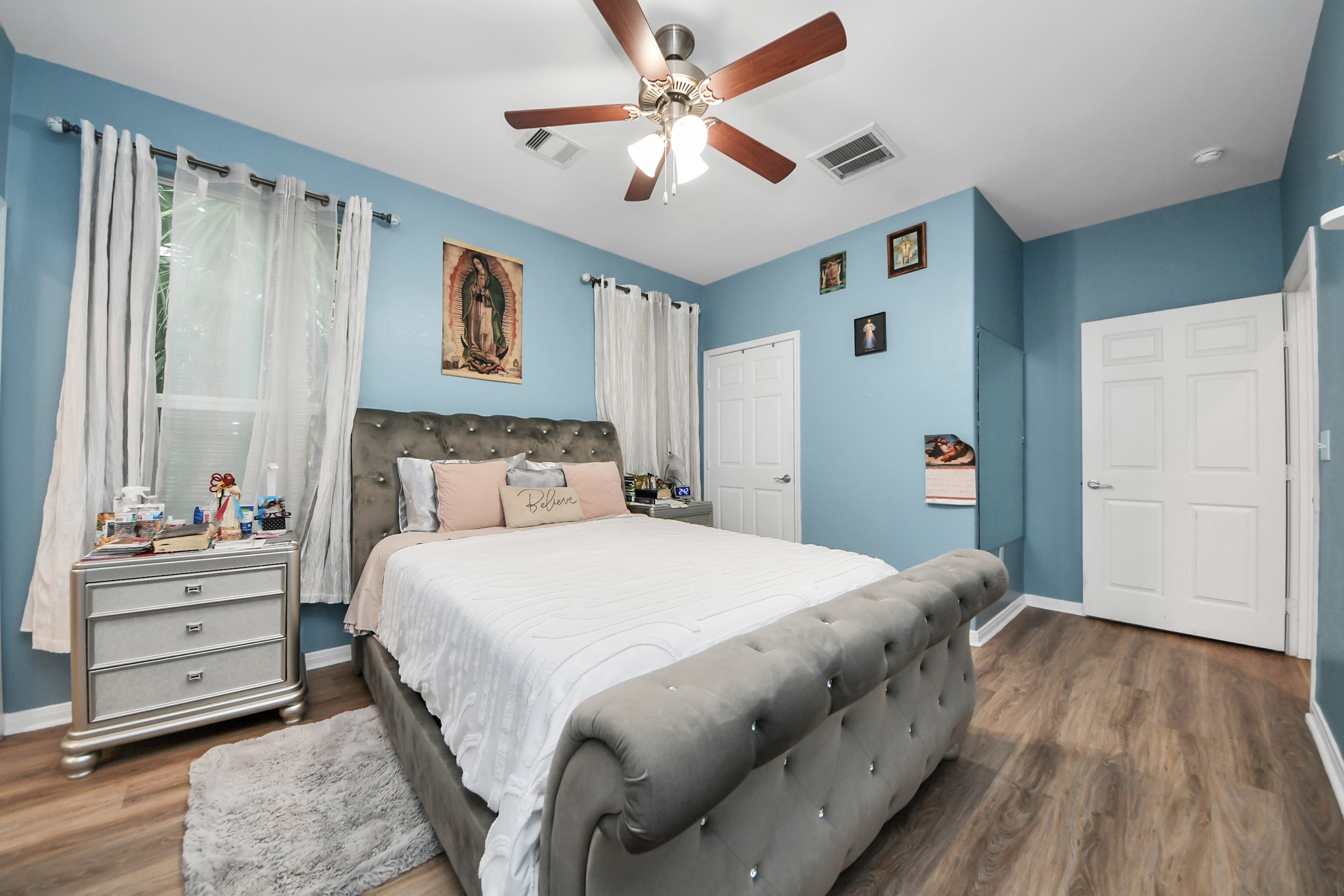 5319 Avenue R Galveston, TX 77551 - Photo 8 of 20 a bedroom with a bed and a chandelier