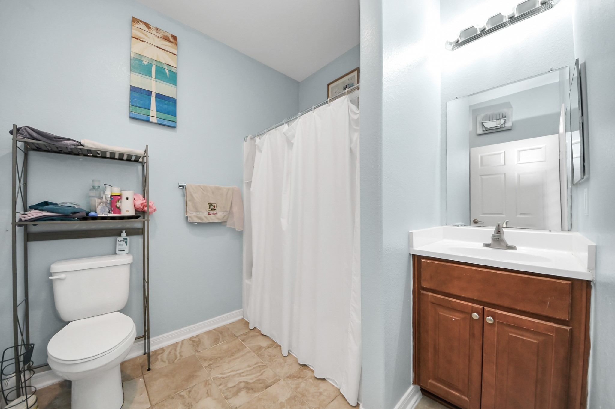 5319 Avenue R Galveston, TX 77551 - Photo 9 of 20 a bathroom with a toilet sink and mirror