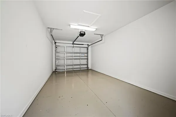 an empty room with stairs and a ceiling fan