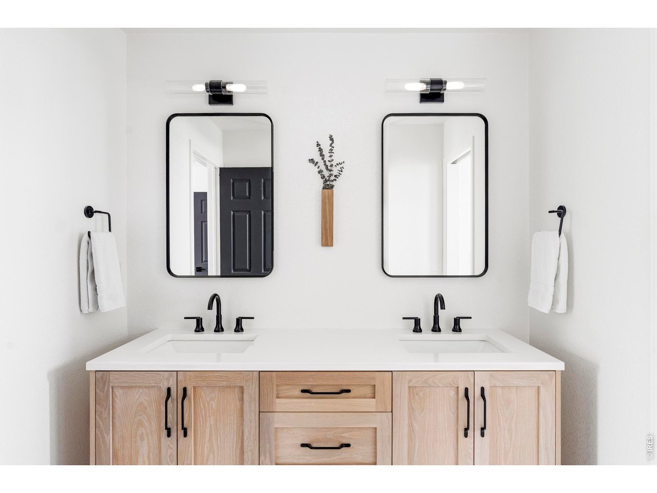 4954 10th Street Boulder, CO 80304 - Photo 15 of 21 a bathroom with double vanity sinks and a mirror