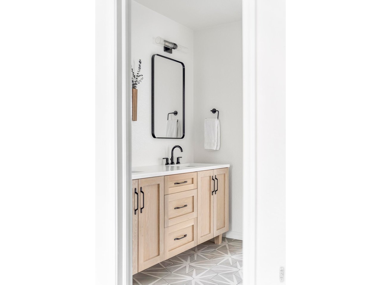 4954 10th Street Boulder, CO 80304 - Photo 16 of 21 a bathroom with a double vanity sink a mirror and